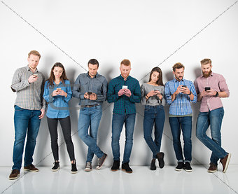 Group of boys and girls connected with their smartphones. Concept of internet and social network