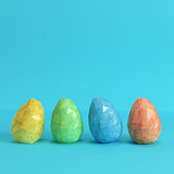 Colorfull easter eggs on bright blue background in pastel colors