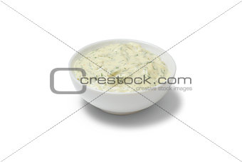 Garlic sauce in a gravy boat on white background