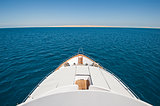 View over the bow over a large luxury motor yacht