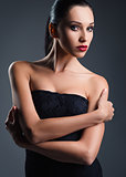 Studio fashion shot: attractive young woman dressed in black 