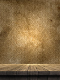 3D wooden table against a grunge damask style wallpaper