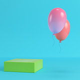 Green box with two flying balloons on bright blue background in 