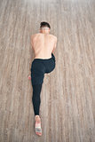 Handsome ballet dancer sitting on a splits