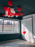 Forever along stand out red heart shape balloon in office below othe balloons. Be special Valentine concept