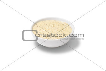 Peanut sauce in a gravy boat on white background