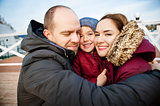 Portrait of happy young couple with son in park