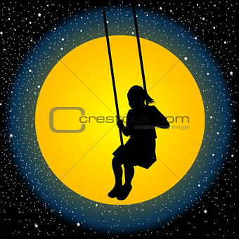 Child having fun on a swing in the night
