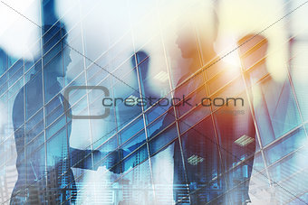 Handshaking business person in office. concept of teamwork and partnership. double exposure
