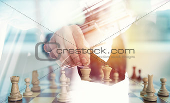 Business strategy with chess game and handshaking business person in office. concept of challenge and tactic. double exposure