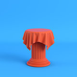Orange cloth on a pedestal on bright blue background