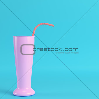 Cocktail glass with straw on bright blue background