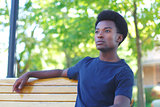 real people young man relaxing on bench park summer portrait spring day