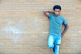 young man standing posing brick wall outside cool attitude city lifestyle 