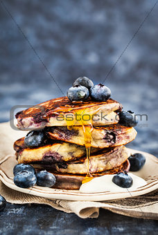 Stack of freshly prepared blueberry ricotta pancakes with fresh 
