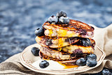 Stack of freshly prepared blueberry ricotta pancakes with fresh 