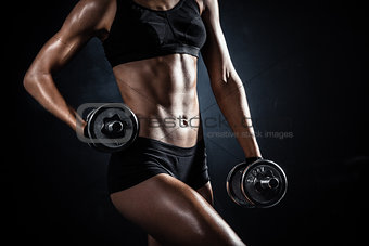 athletic woman with dumbbells
