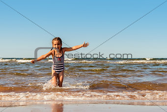 Little girl playing on the Brackley beach