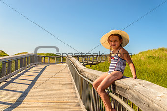 Little girl having fun on boardwalk to Brackley Beach