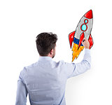 Businessman drawing a rocket. Concept of business improvement and enterprise startup