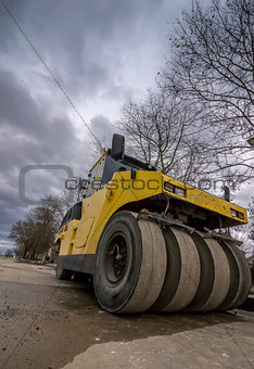 Close view on the road roller. Street paving works. Wide angle