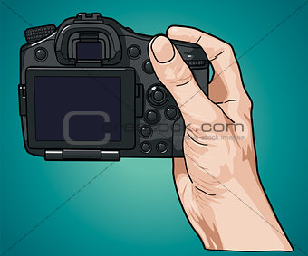 Hand holding professional photo camera