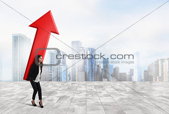 Businesswoman holds a big arrow. Concept of business growth and success
