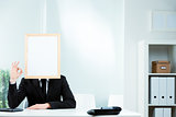Businessman with a blank picture frame for a face