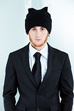 Strange businessman wearing a knitted cap and suit
