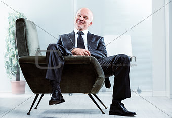 Relaxed businessman with a satisfied smile