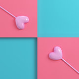 Two pink hearts on a stick on bright red blue background in past
