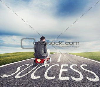 Man runs with a toy car on success way. Concept of successful businessman and company startup