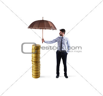 Businessman protects his money savings with umbrella. concept of insurance and money protection