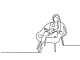 Woman sitting with book in chair