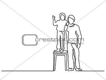 Father with little son standing on a stool