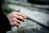 man smoking a hand-rolled cigarette or a joint