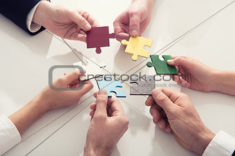 Teamwork of partners. Concept of integration and startup with puzzle pieces