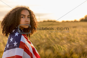 Sad Depressed Girl Woman Teenager Wrapped in USA Flag at Sunset 