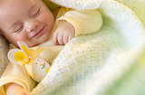 Cute baby sleeping with Easter decorations