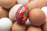 Egg Easter red on the background of unpainted eggs.