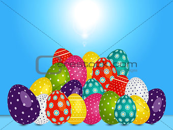 Loads of decorated Easter eggs over blue sunny sky