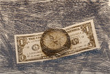     Ancient compass on the background of banknotes tapered.