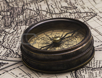 Ancient compass on the world map.