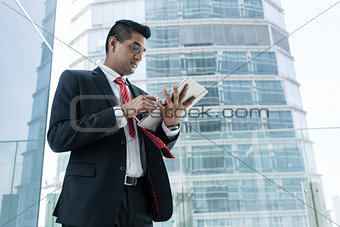 Indian businessman analyzing financial report indoors