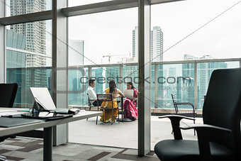 Indian employees during break on the terrace of a modern building