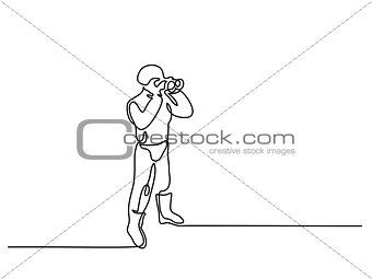 Standing policeman holding binoculars