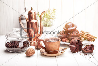 Coffee in clay cup with chocolate muffin