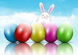 Easter bunny and eggs on a blue sky background