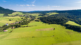 Road, forest, village and field summer landscape from above - drone view