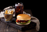 Fresh beef burger with potato wedges and cola